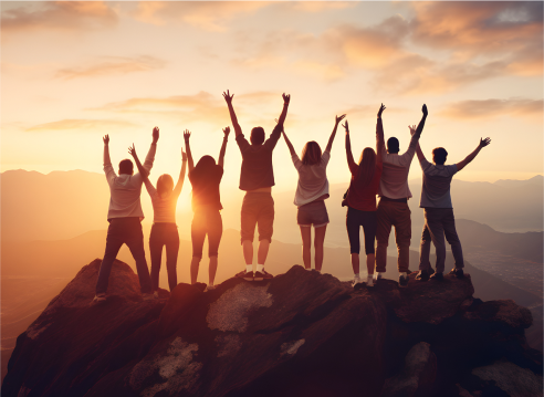 group of people standing on mountaintop over the sun rising from horizon